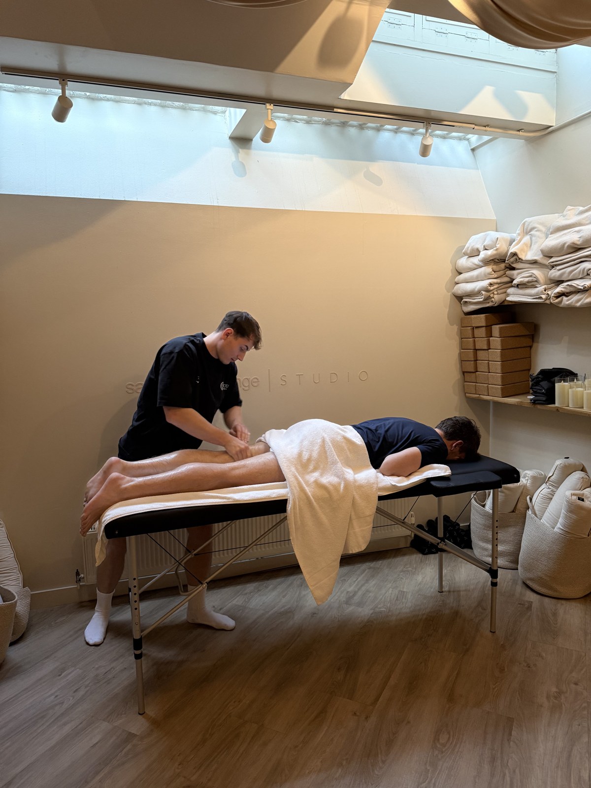 A Corpus Health practitioner treating a client during an on-site session